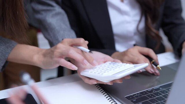 Female accountant working on financial investment on calculator, calculation, analysis of company income.