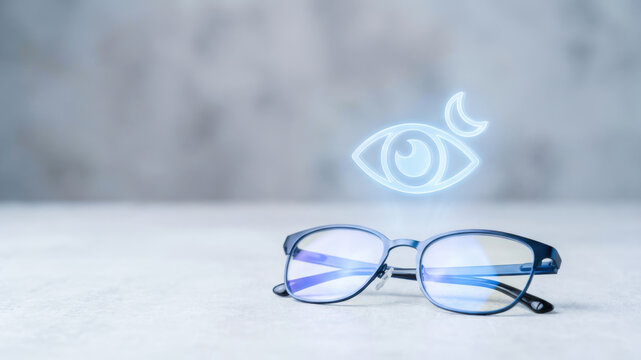 Eyeglass frame with blue lens reflection and glowing eye symbol on pale surface, suggesting vision care, optical health, and focused sight