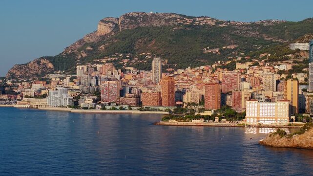 Aerial view of Montecarlo coastline with city buildings and hills at sunset