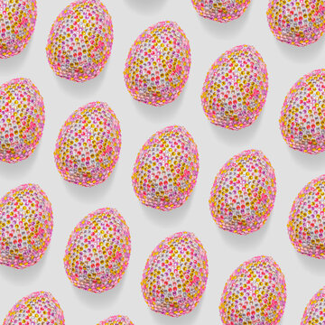 Colorful easter eggs in shiny sequins as minimal trend repeat pattern on light gray. Pop art still life close up photo of sparkling rhinestones pink egg, spring easter holiday concept, modern design.