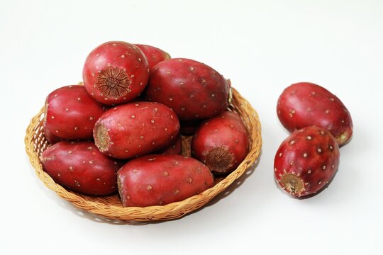 Fresh Red Prickly Pear Cactus Fruits in a Wicker Basket on White Background