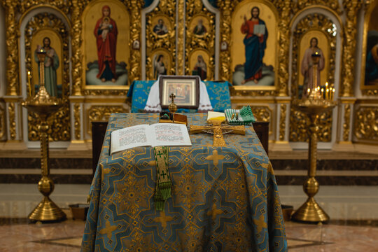 Golden iconostasis and religious icons in the ornate interior of an Orthodox church