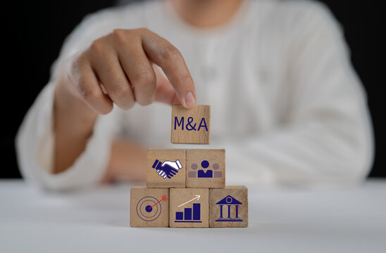 Business mergers and acquisitions concept. Share acquisition, asset business acquisition, amalgamation. Business review and development model. The abbreviation M and A on smart background, copy space.