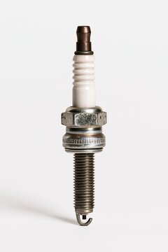 Closeup of old spark plug on white background