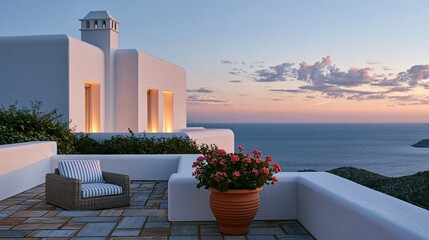 Obraz premium White terrace with wicker chair overlooking ocean sunset