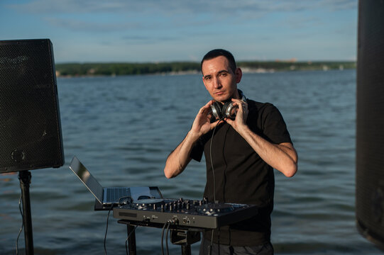 Portrait of a DJ on the river bank. 