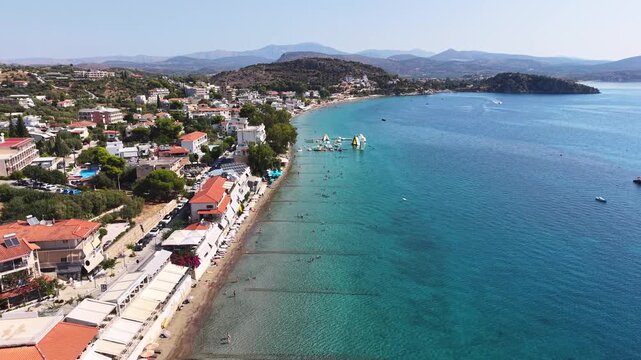 Aerial footage over Tolo village with turquoise waters and sand beach in the Peloponnese, Greece