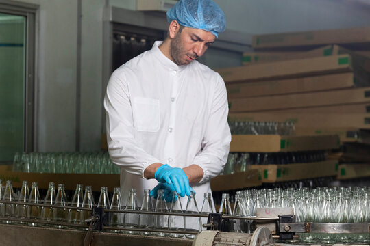 QC worker checking production line safety and hygienic standard in food and drink factory.