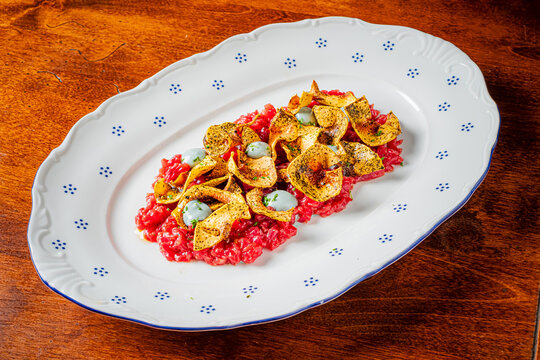 Savoring a culinary masterpiece with crispy toppings and vibrant colors on a rustic table