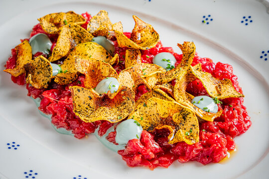 Delicious tartare served on a beautiful plate with crispy chips