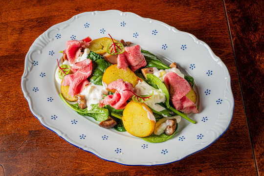Delicious salad featuring fresh ingredients and tender meat on a beautifully crafted plate