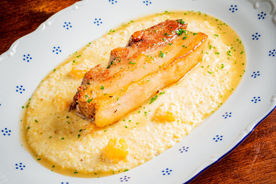 Savoring Southern flavors with crispy pork belly over creamy grits
