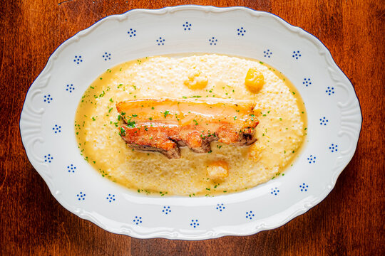 Delightful culinary creation featuring succulent meat over creamy base on a beautiful plate