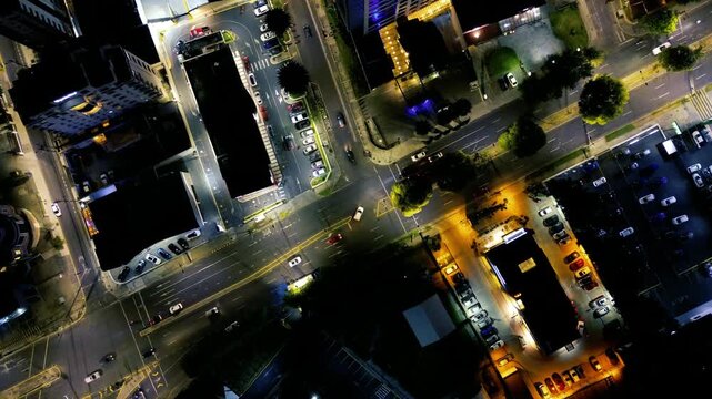 Top Down Night Drone View of Quito Ecuador Intersection, Illuminated Roads, Buildings, Traffic Lines and Urban Infrastructure Pattern