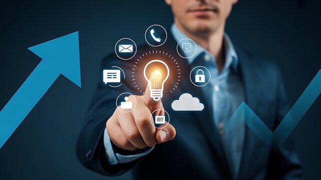 Businessman touching glowing light bulb with digital icons on growth chart background symbolizing innovation and success