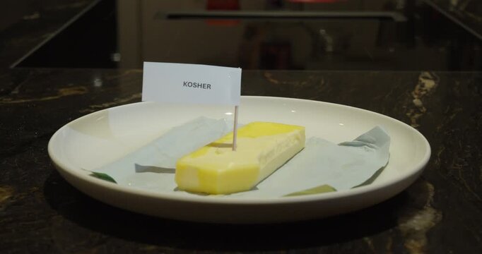 Kosher dairy concept with butter on a plate.