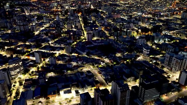 Night Aerial View of Quito Ecuador Urban District with Dense City Lights, Streets, Buildings and High Altitude Mountain Capital Landscape