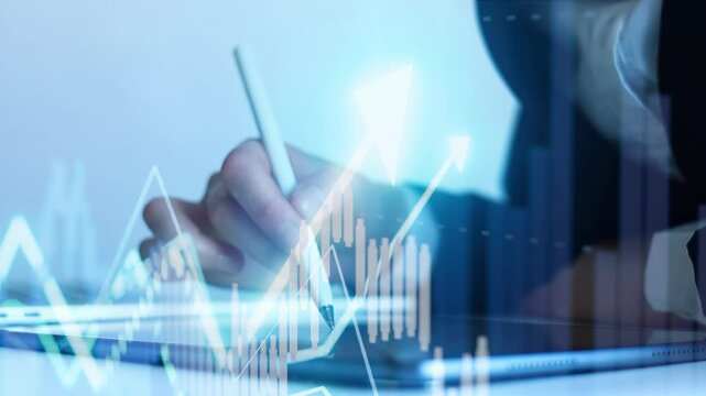 A business professional is using a tablet to review financial data. Graphs and charts are displayed, showing market trends and statistics. The setting suggests a workspace environment.