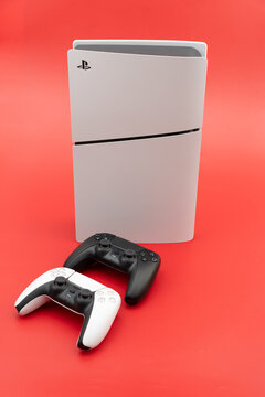Bogota, Colombia - August 2026 Playstation 5 slim console with dualsense controllers on red background