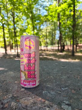 can of hell energy drink against the background of a city park