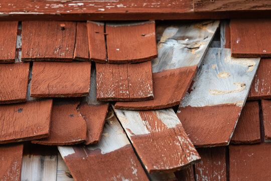 Damaged weathered wooden shingles needing home repair