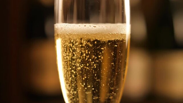 Close-up of champagne pouring into a goblet, close-up of champagne pouring into a goblet
