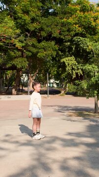 Young Thai Girl Playing with Hula Hoop in Lumpini Park