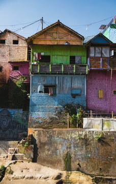 Vibrant Painted Houses and Wooden Balcony on River Embankment at Kampung Warna Warni Jodipan in Malang East Java Indonesia