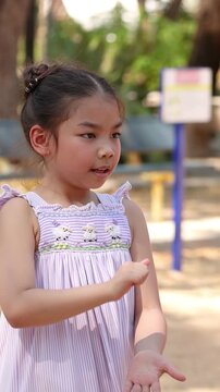Young Thai Girl Playing Hand Games at Lumpini Park Playground