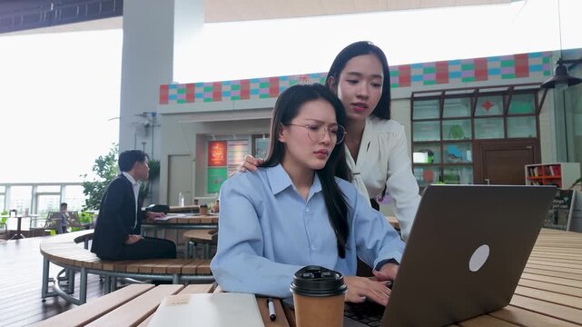 Stressed Asian Businesswomen Working on Laptop in Bangkok Office
