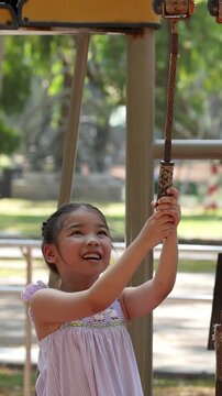 Young Thai Girl Playing on Exercise Equipment at Lumpini Park