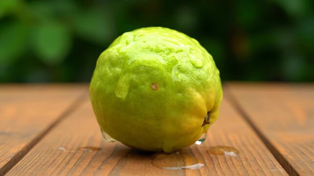 Close-up of guava and green lemonade drops on a wooden table