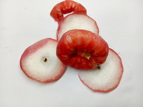 Top Angle View of Whole and Sliced Fresh Water Apple Fruit on White Background