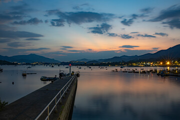 Fototapeta premium Beautiful sunset at Tai Mei Tuk in Summer. Tai Po, Hong Kong. Long Exposure