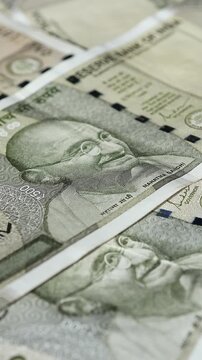 Сlose-up view of Indian 500 rupee (INR) banknote and portrait of Mahatma Gandhi with changing selective focus. Concept of saving money, cash payments, financial literacy, Indian economy.	