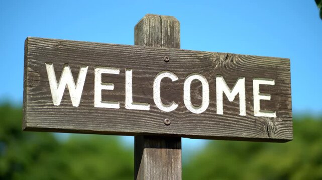 Close-up of wooden welcome sign, close-up of outdoor wooden welcome sign