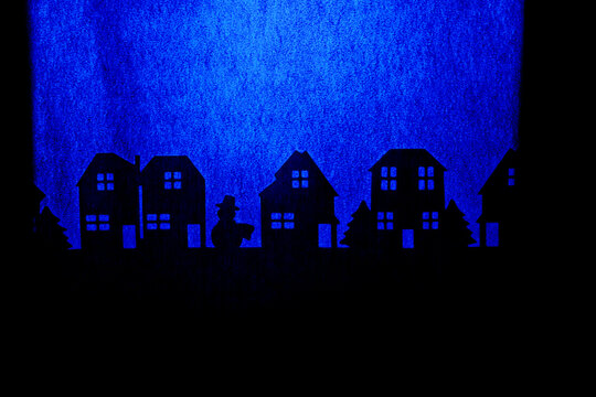 Silhouettes of houses and trees on a blue background
