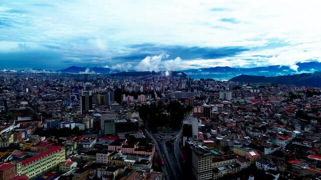 Panoramic Aerial View of Quito Ecuador Skyline with Dense Urban Buildings, Mountain Basin, Blue Clouds and High Altitude City Landscape