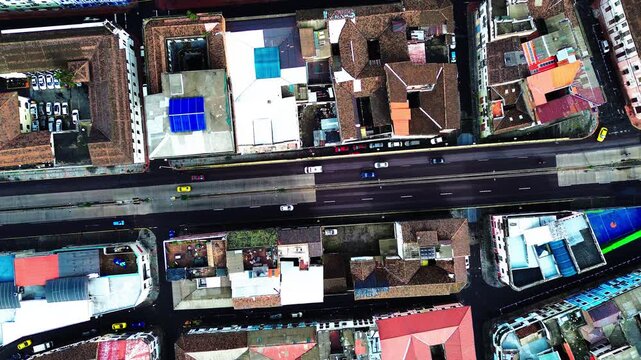 Top Down Drone View of Quito Ecuador City Blocks with Rooftops, Streets, Sports Courts and Urban Infrastructure, High Altitude South American Capital Background