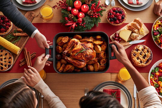 Thanksgiving feast overhead with roasted turkey, pumpkin soup, lattice pie, cranberry sauce and mashed potatoes