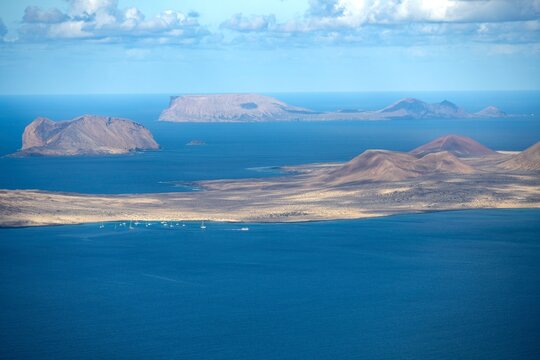 View from the Castillejo viewpoint from the Risco de Famara cliff to the sea and the islands of La Graciosa Isla La Aleganca and Isla de Monta&ntilde;a Clara, Lanzarote, Canary Islands, Spain