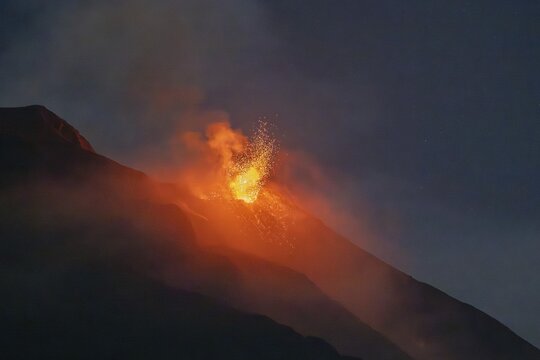 Crater, lava eruption on a slope, volcanic eruption at night, Stromboli volcano, Mediterranean lighthouse, Aeolian or Lipari islands, Tyrrhenian Sea, Sicily, southern Italy, Italy