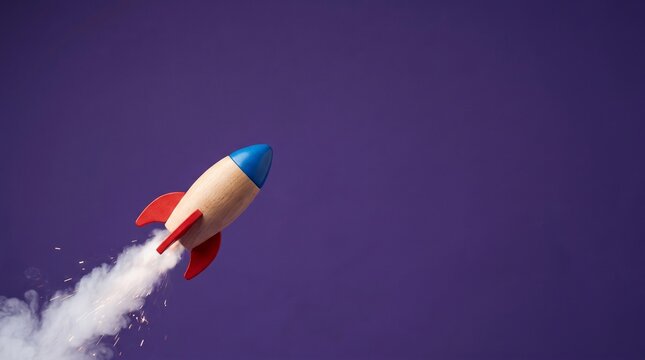 Colorful toy rocket launching upward with smoke trail against gradient sky background
