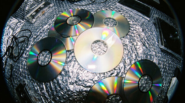 Blank Compact Discs with Iridescent Rainbow Reflection on Metallic Bubble Wrap, 90s Fisheye Still Life