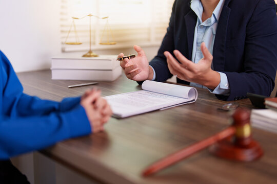 Lawyer explaining contract terms to client in office meeting for legal advice concept