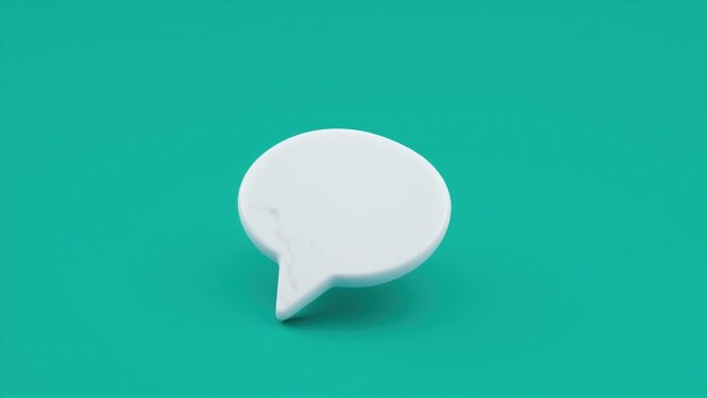 White speech bubble sits upon teal surface. Minimalist design, clean aesthetic, simple studio shot. Focus on communication concept.