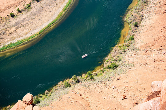 Aerial View of Deep Blue Water Surrounded by Dry Desert Rocks at horseshoe bend in USA