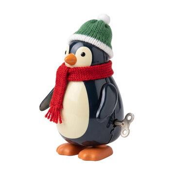 Cute Christmas wind-up toy penguin with knitted scarf, painted metal body and playful winter character design on transparent background