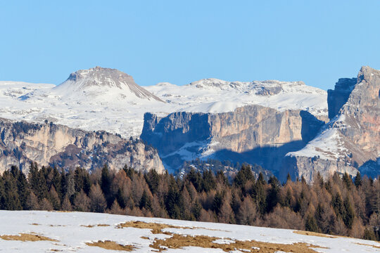 Winter panorama of pristine snowfields and rugged Dolomite peaks near Rifugio Fuciade in northern Italy