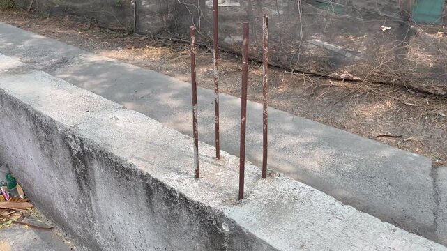 Row of Steel Rebar Embedded in Concrete Foundation for House Building